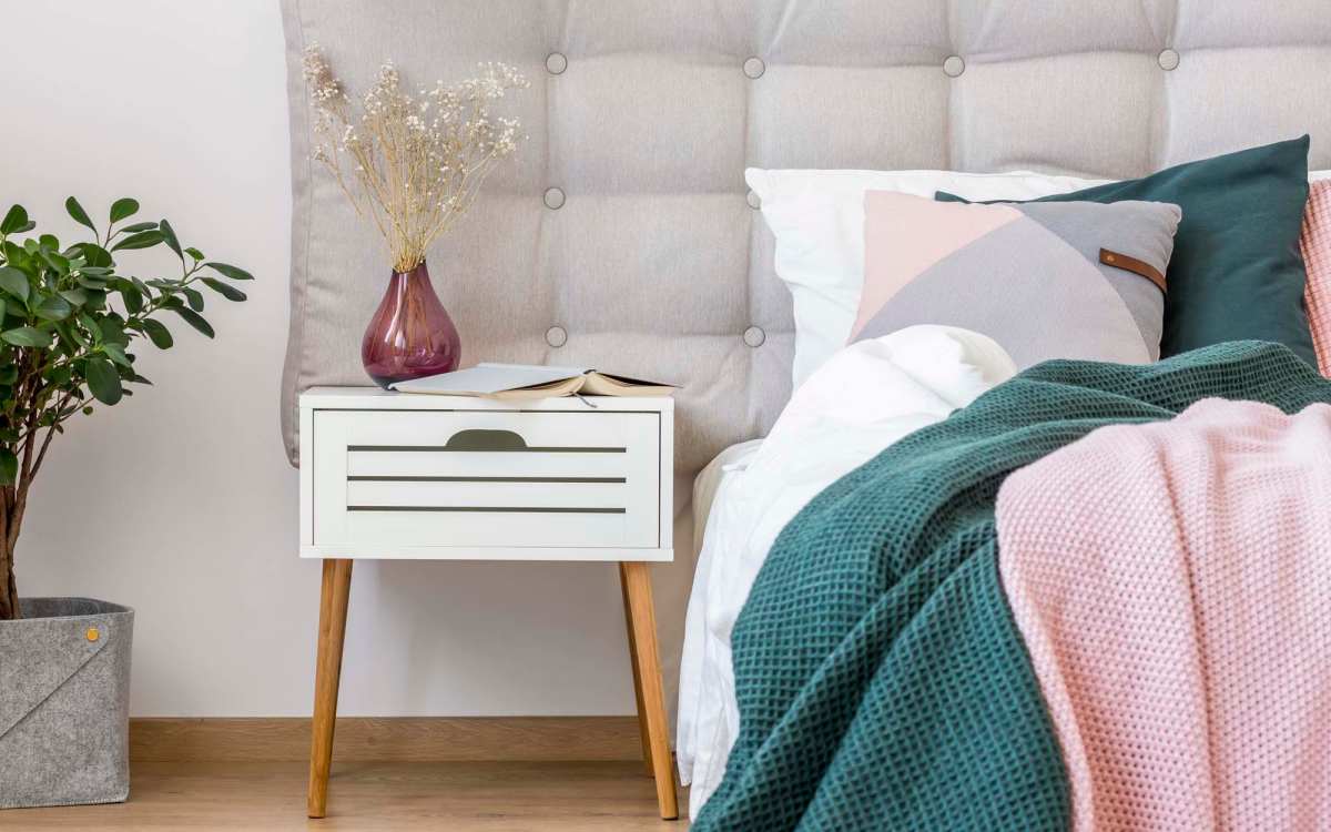 A well-furnished and bright apartment bedroom at Golden Villas in San Diego, California