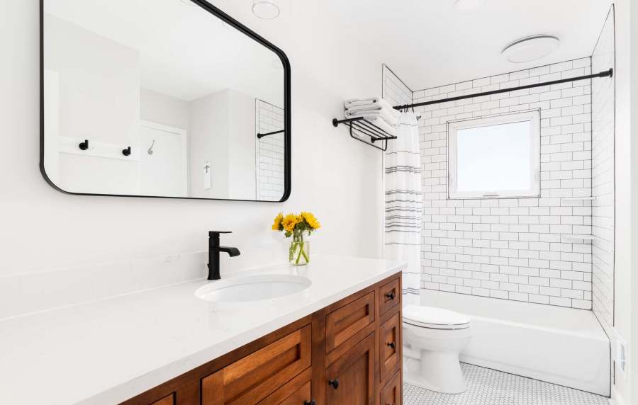 Modern bathroom with large mirror at Amber Court in Fremont, California