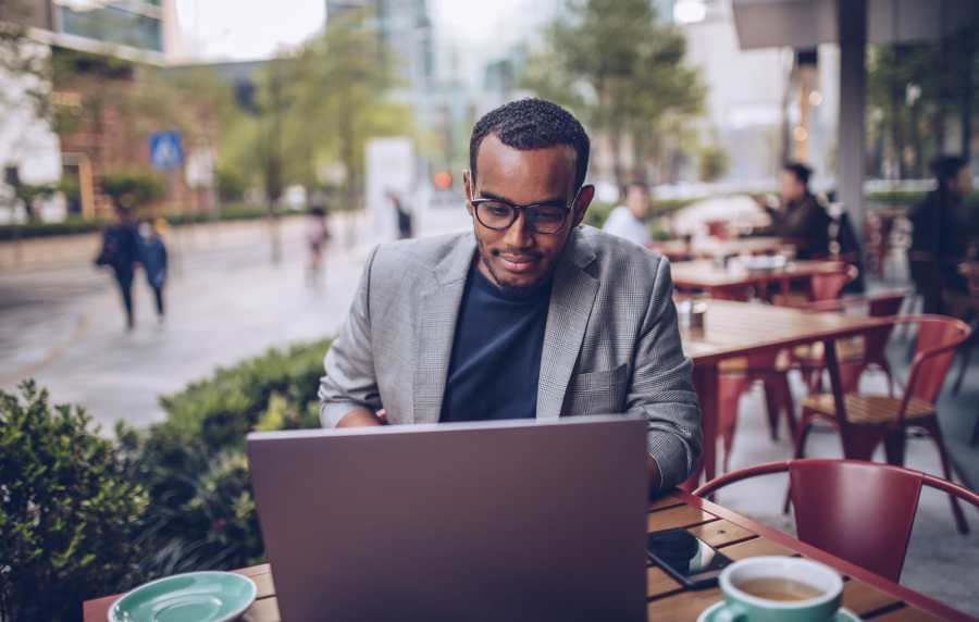 Resident working outside on his laptop near Villa Del Sol in Sunnyvale, California