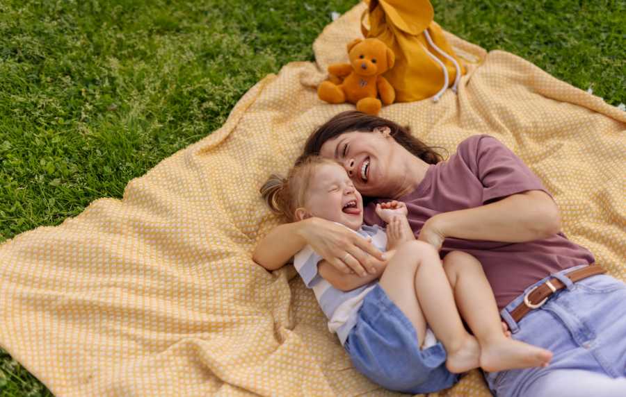 Resident playing with her kid in the park near Orleans at Fannin Station in Houston, Texas