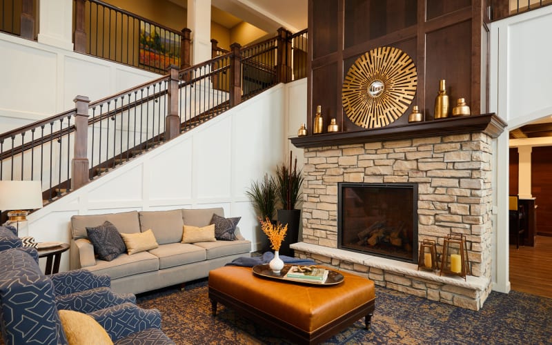 Seating area with fireplace and couches at Amira Choice Plymouth in Plymouth, Minnesota