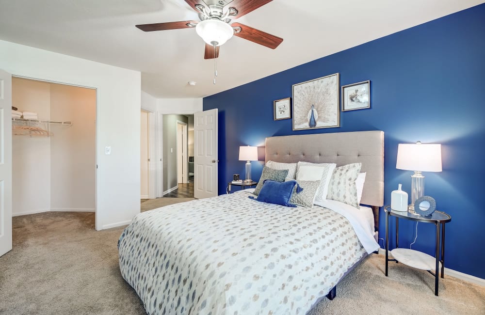 Bedroom with ceiling fan and large windows at The Woods at Polaris Parkway Apartments & Townhomes in Westerville, Ohio
