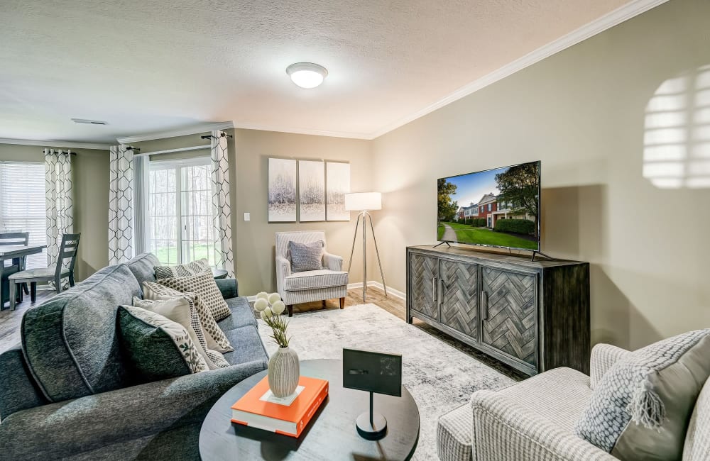 Living room with wood style flooring at The Woods at Polaris Parkway Apartments & Townhomes in Westerville, Ohio