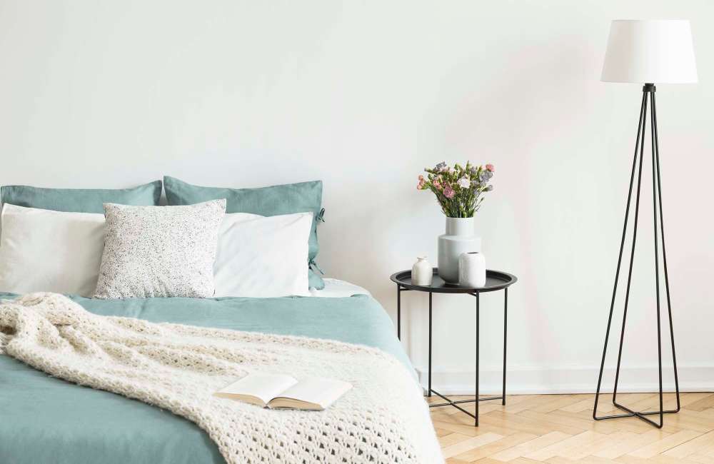 Modern bedroom with wood-style flooring, side table and lamp at Douglas Park in Compton, CaliforniaDouglas Park in Compton, California