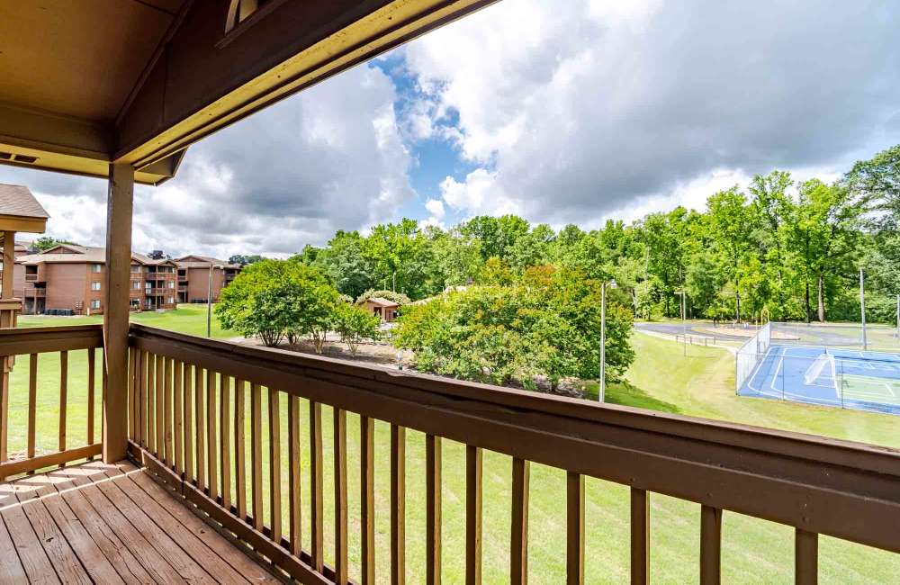 Balcony with view of a sports court at Riverwind Apartment Homes in Spartanburg, South Carolina