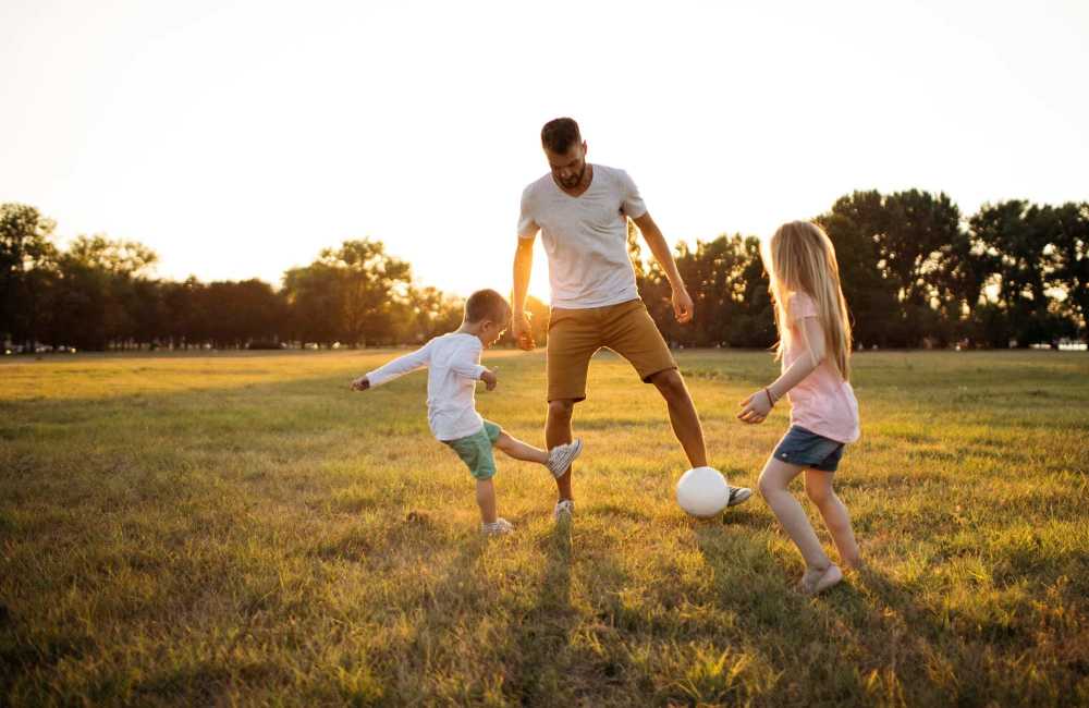 Father playing with his children near Riverview Gardens Apartments in Fresno, California