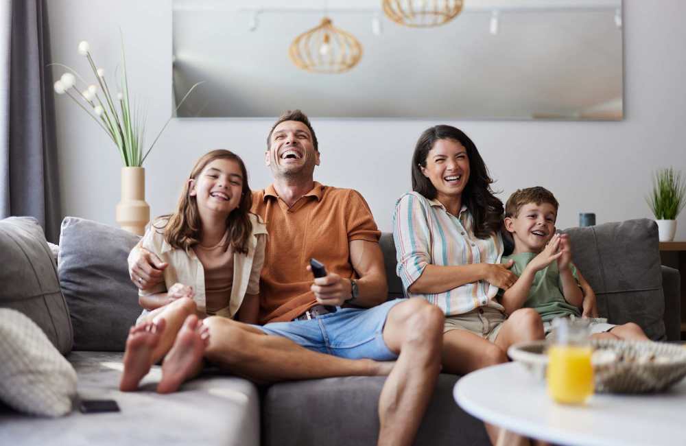 Resident family relaxing in a living room at Hillside Apartments in Laredo, Texas