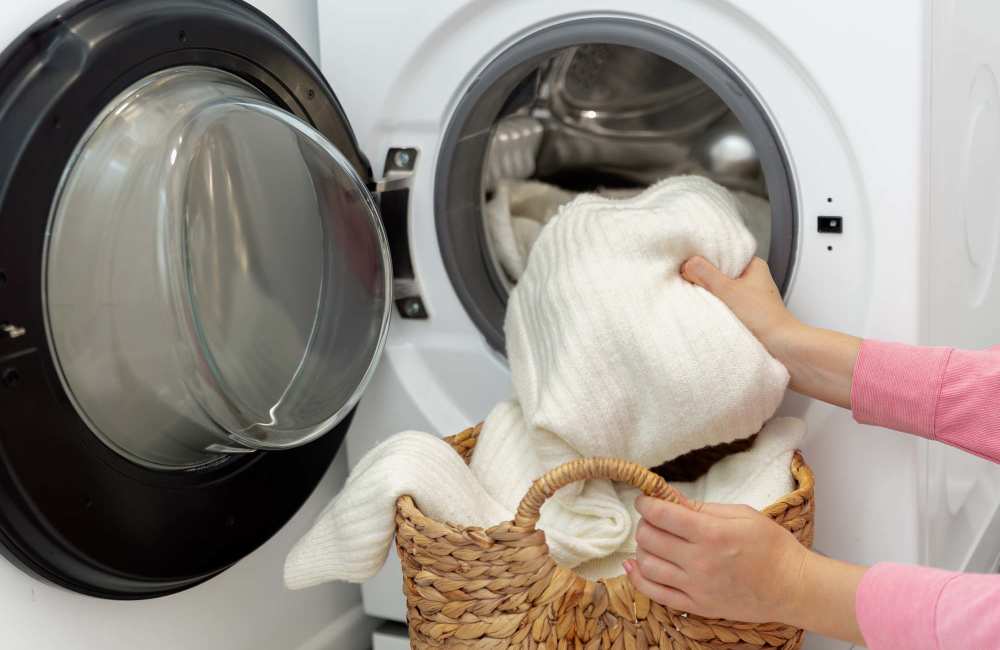 Laundry being loaded into washing machine at The Barstow in Austin, Texas