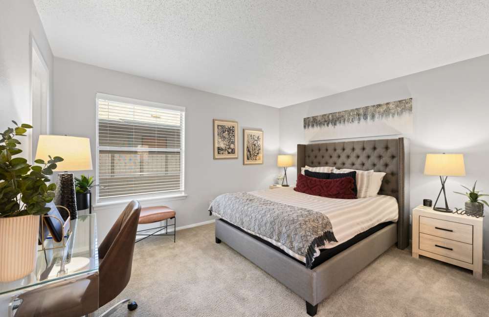 Comfortable bedroom with a large bed and carpet flooring  at 18Eleven Frankford in Carrollton,Texas