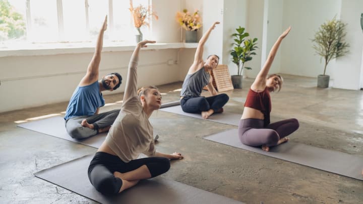 A small group of people practicing yoga at a yoga class | yoga studios around Charlotte
