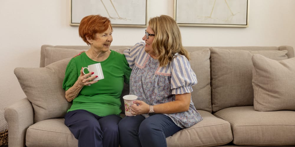 Resident looking through photos with a staff member at Barclay House of Stuart in Stuart, Florida