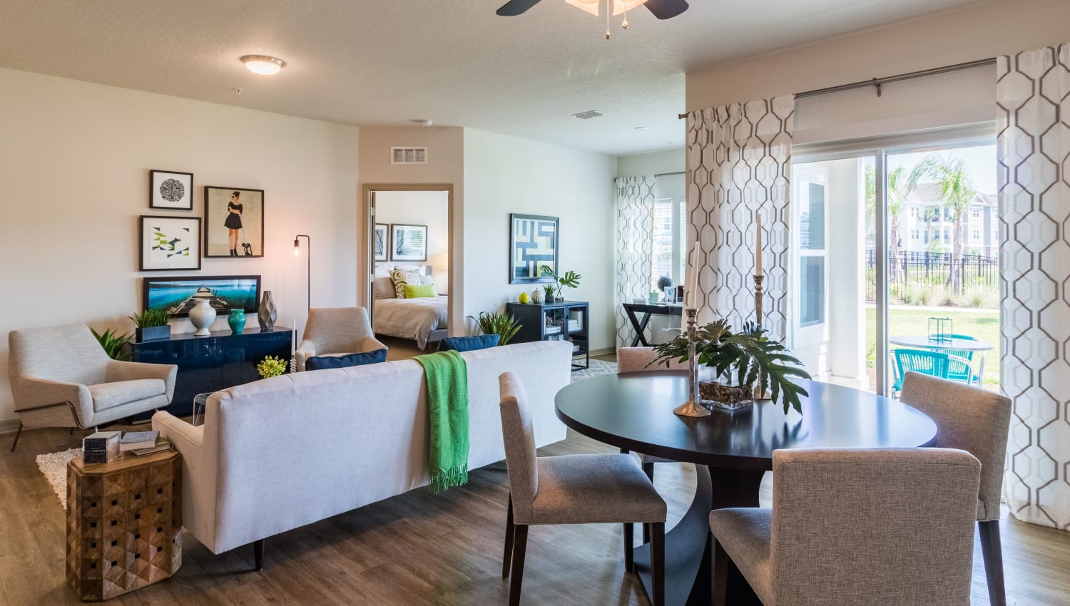 Dining nook and living room with large windows at Lakeline at Bartram Park in Jacksonville, Florida