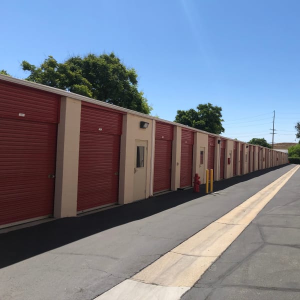 Outdoor storage units with red doors at StorQuest Self Storage in Temecula, California