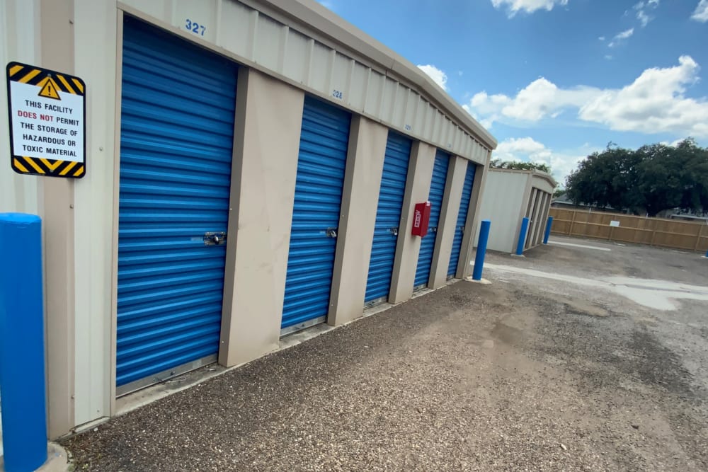 Outdoor storage units with blue doors at KO Storage of Eagle Pass - Cenizo Trail in Eagle Pass, Texas. 