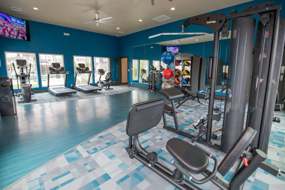 Well-equipped fitness center at Bend at New Road Apartments in Waco, Texas