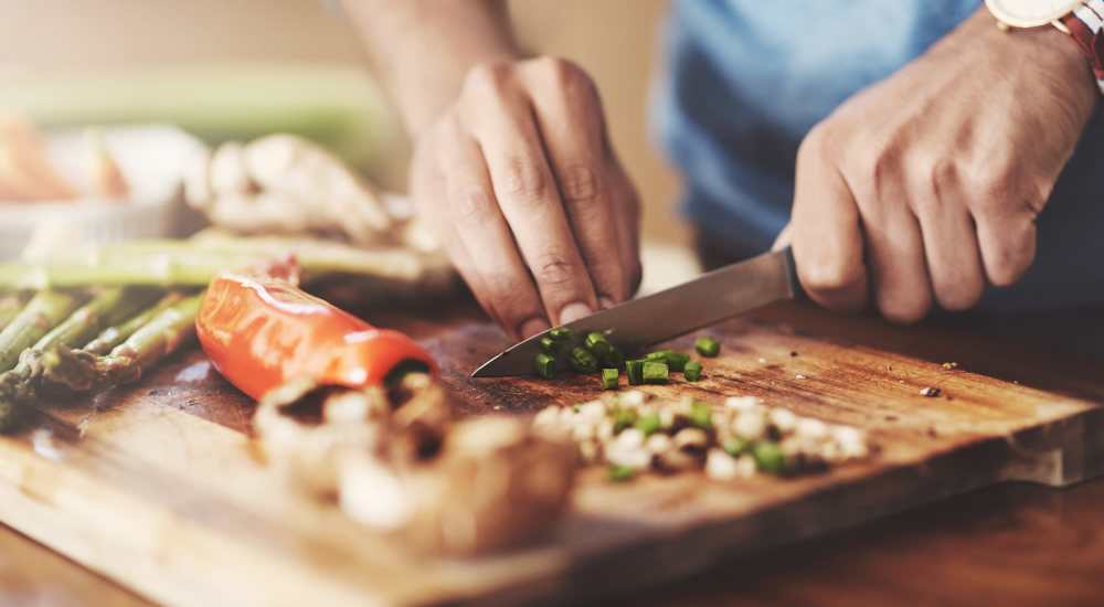 Resident chopping vegetables in the kitchen at Country Oaks in Weatherford, Texas 
