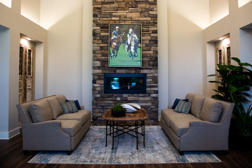 Fireplace lounge with sofas and chairs for visiting at Westminster Memory Care in Lexington, South Carolina