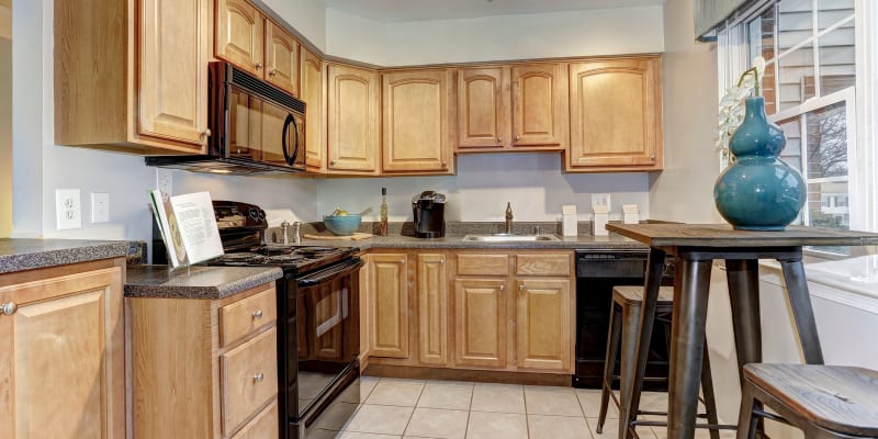 Model kitchen with dining table at Olde Forge Townhomes in Perry Hall, Maryland