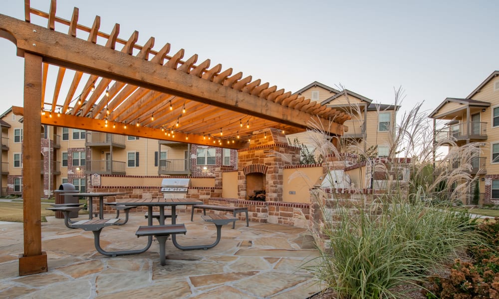 Outdoor covered patio area at Portico at Friars Creek Apartments in Temple, Texas