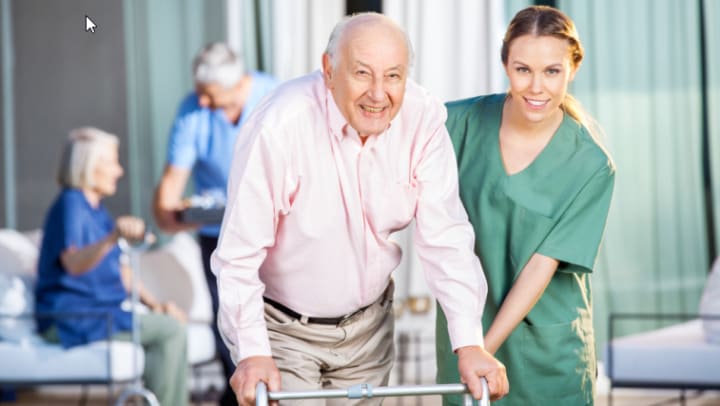 Caregiver helping senior resident with a walker