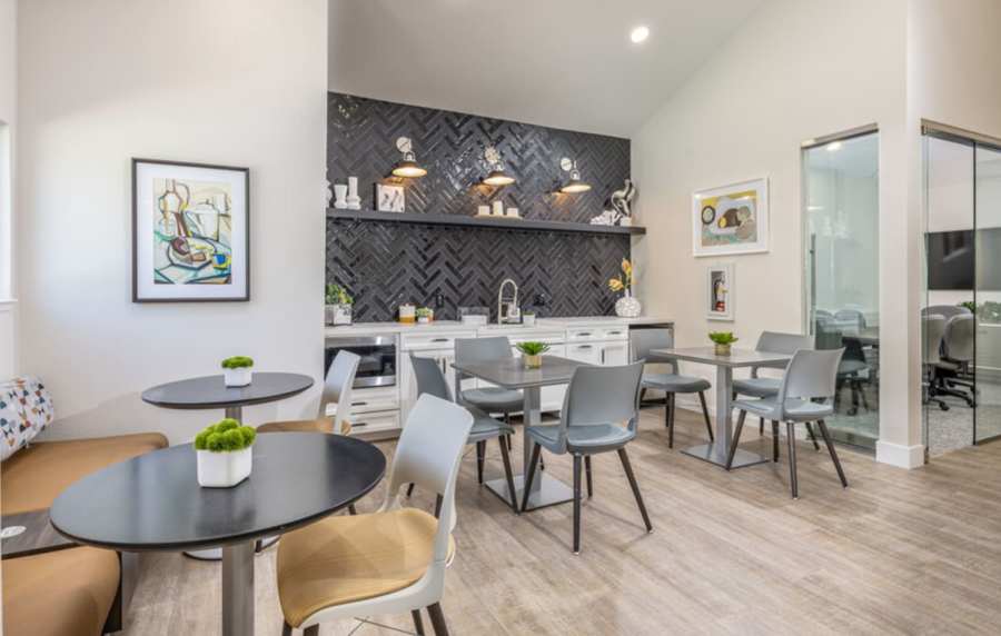 Spacious clubhouse with wood-style flooring at Amber Court in Fremont, California,
