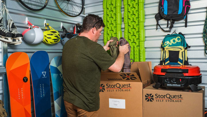 Man in Storage unit with sporting goods.
