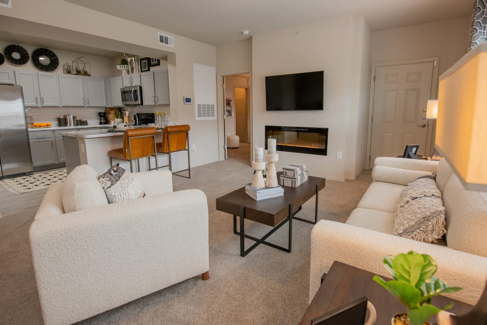 LED fireplace and open kitchen at Bend at New Road Apartments in Waco, Texas