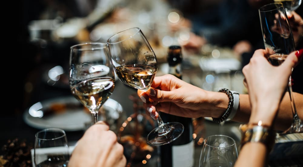 A group of people holding wine glasses near The Courts of Avalon in Pikesville, Maryland