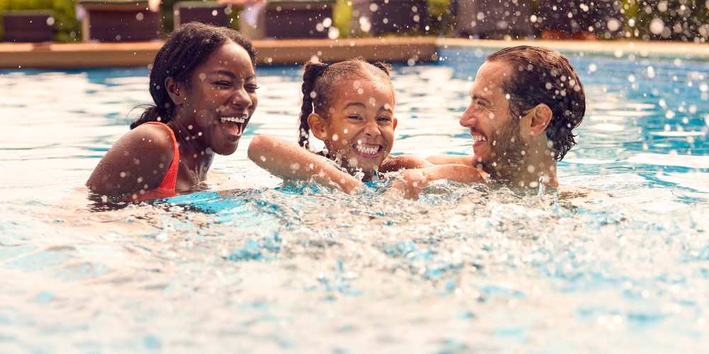 Resident family enjoying in pool at Ballantyne Commons of Columbus in Columbus, Georgia