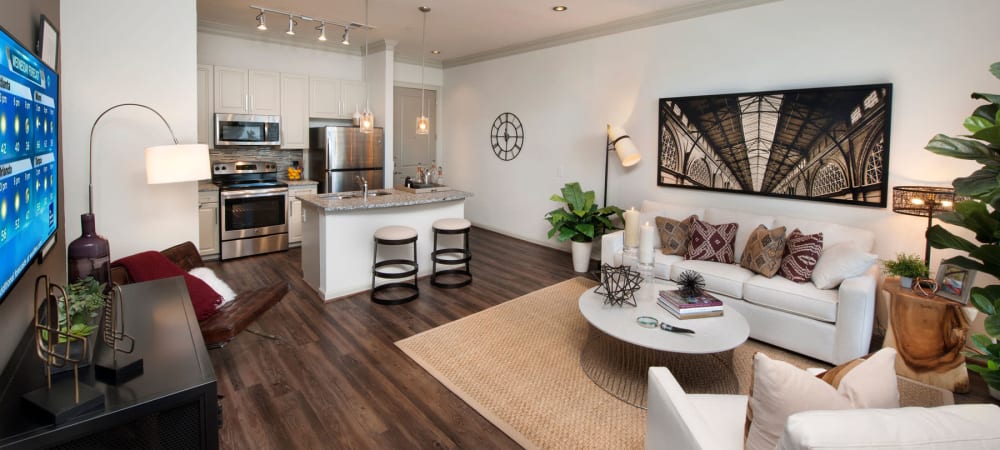 Kitchen area and living room with tons of natural light and a ceiling fan to stay coo at 2370 Main at Sugarloaf in Duluth, Georgia