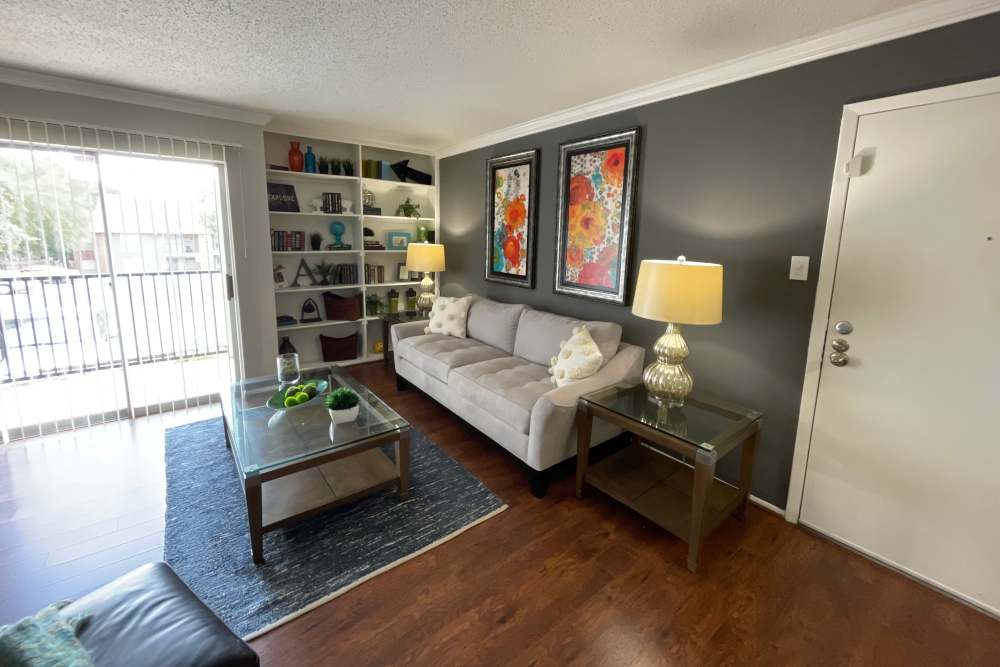 Living room with patio access at The Abbey at Medical Center in San Antonio, Texas