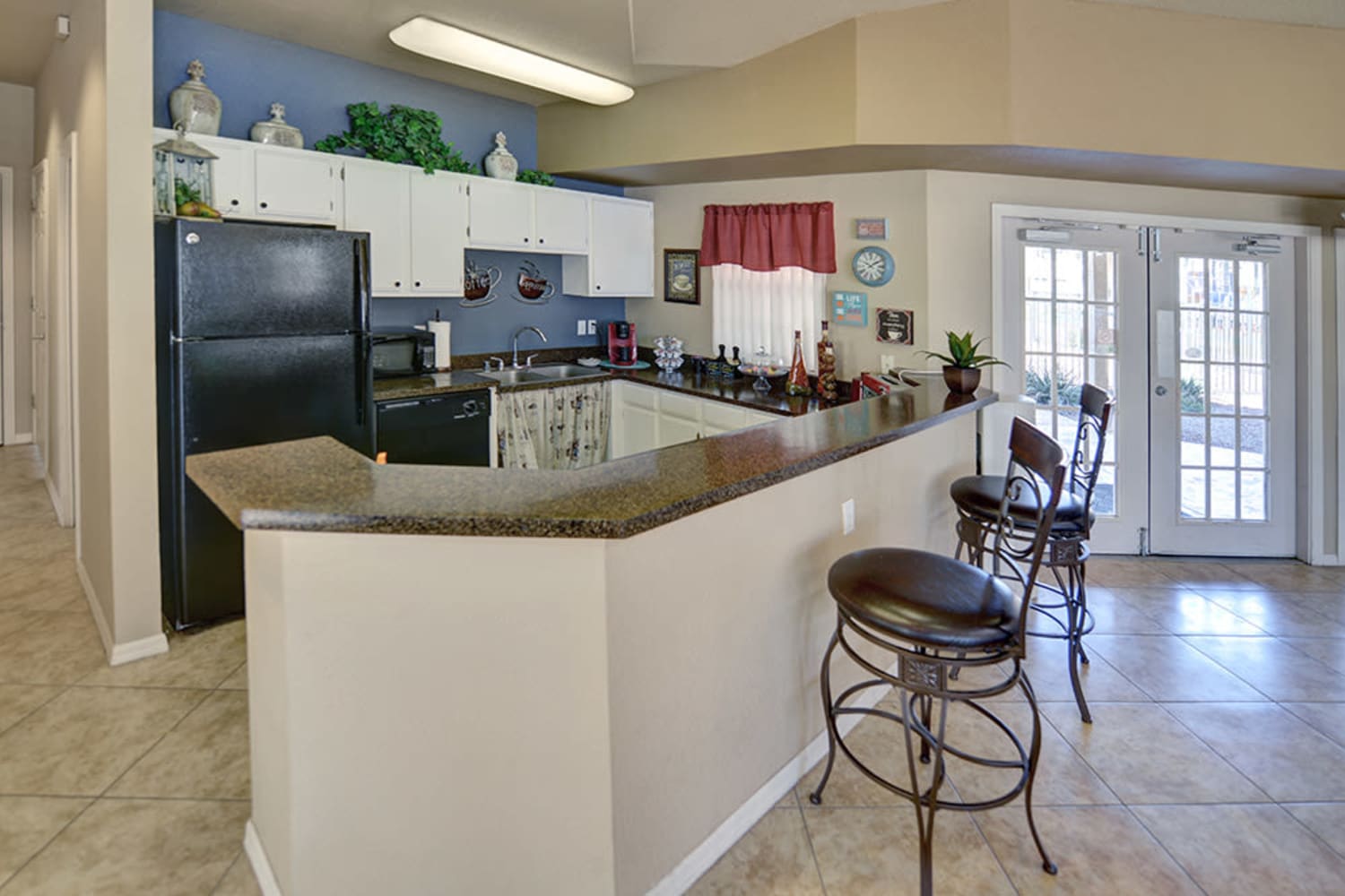 Spacious kitchen with dark counters and white cabinets at Cottonwood Crossing Apartments in Casa Grande, Arizona  