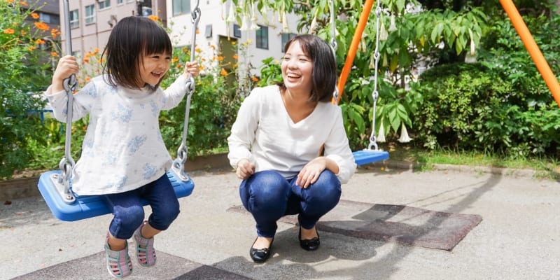 A woman and her daughter on the swings at a school near Albany Hill Village in Albany, Georgia