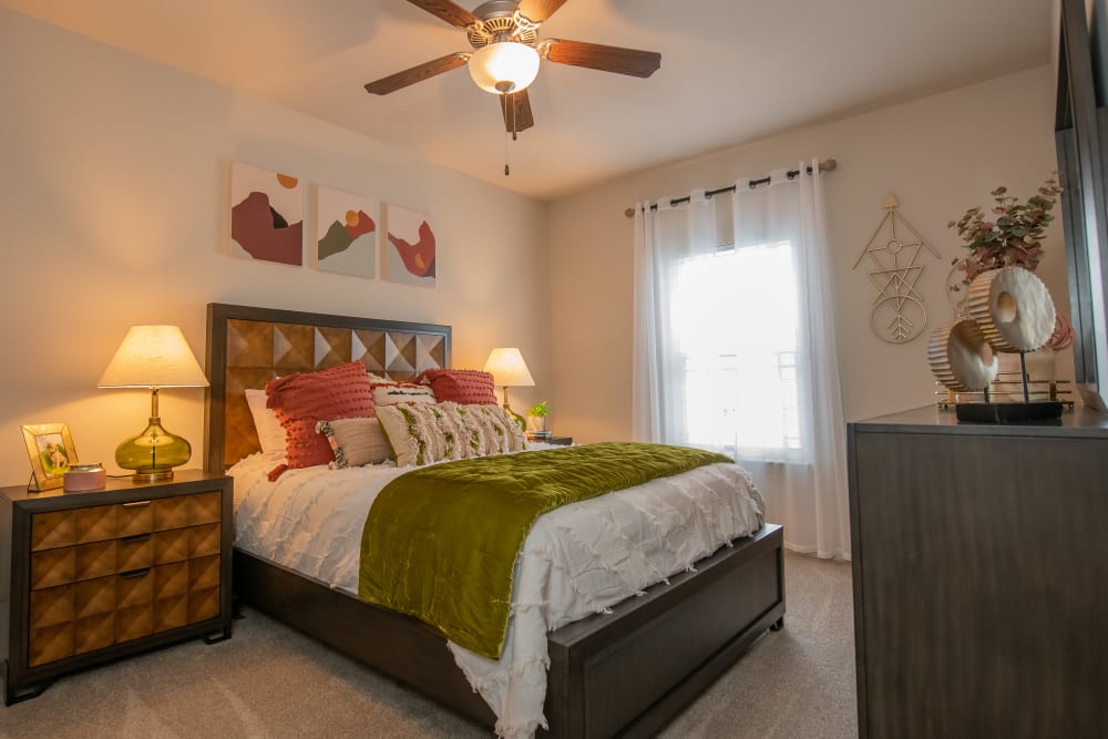 Spacious bedroom with a ceiling fan at Bend at New Road Apartments in Waco, Texas