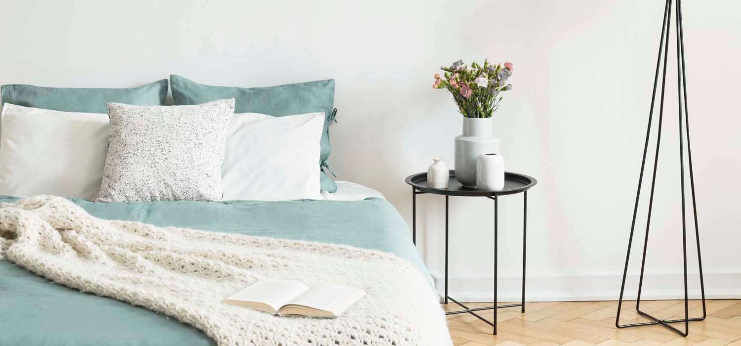 Cozy bedroom with a potted plant on a table at Indian Terrace Villas in Auburn, Indiana