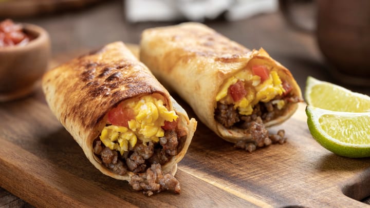 Two breakfast burritos on a plate from a restaurant in Keller.