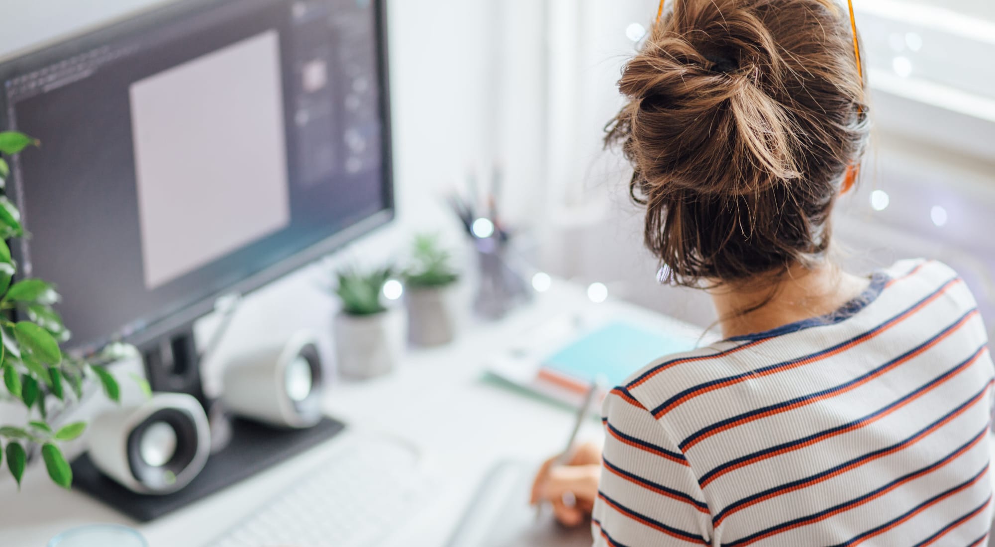 Woman editing photos in her apartment at Fusion apartments in Jacksonville, Florida