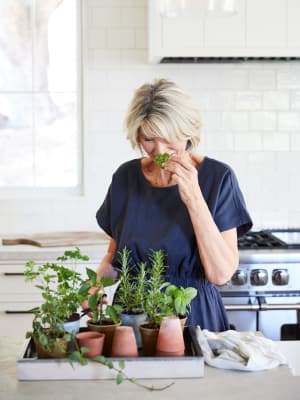 Woman smelling herbs at Avenida Partners, LLC in Newport Beach