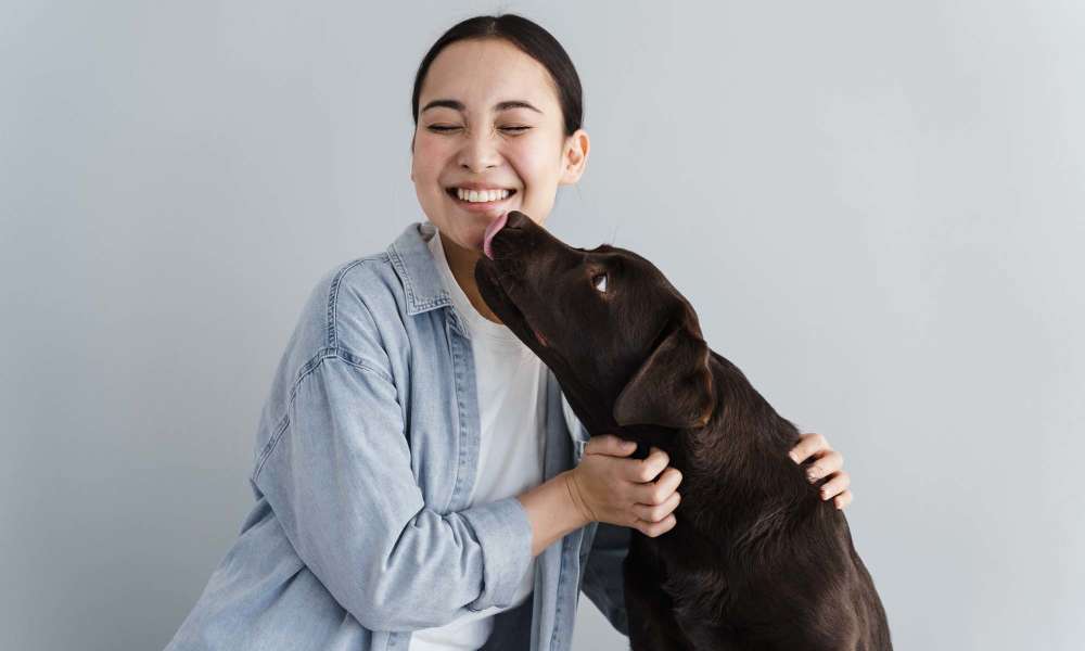 Resident playing with her dog at Riverwood Apartments in Reno, Nevada