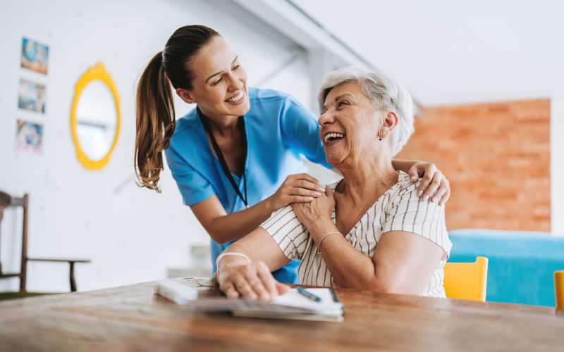 Resident with staff member posing for a photo together at Grand Villa of Ocala in Ocala, Florida