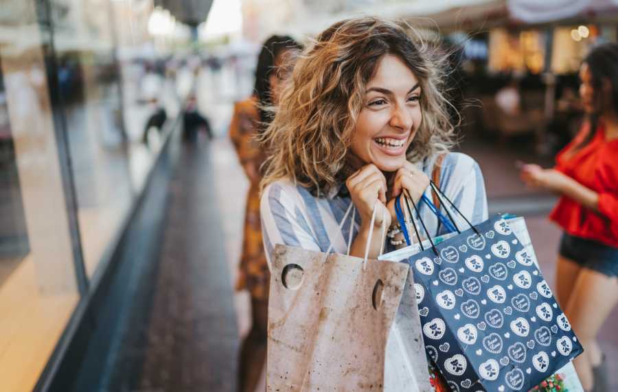 Happy resident woman shopping near Parcwood Apartments in Corona, California