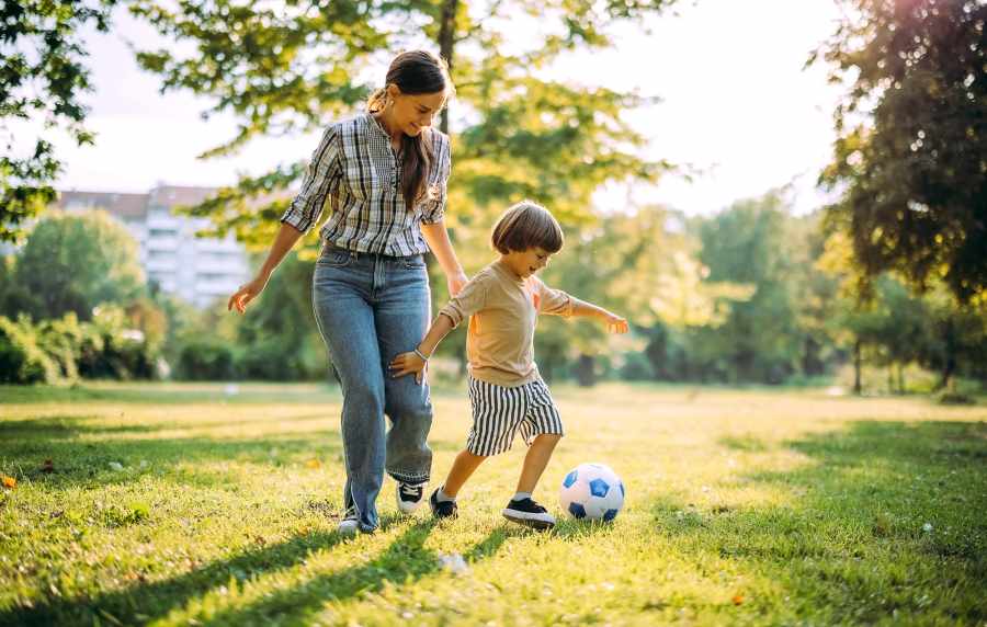 Resident and kid playing in a park near Red Knot at Edinburgh in Chesapeake, Virginia