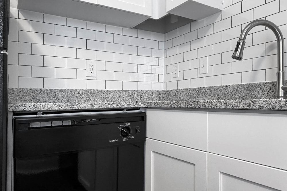 New Upgrades in Select Units: Subway Tile Backsplash, Granite Countertops and Sleek Black Dishwasher The Hills at Oakwood Apartment Homes in Chattanooga, Tennessee
