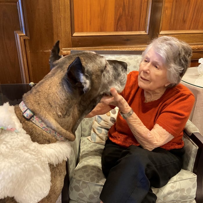 Resident petting a dog at The Clinton Presbyterian Community in Clinton, South Carolina