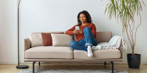 Resident relaxing on the couch with coffee at Highpoint Club in Orlando, Florida