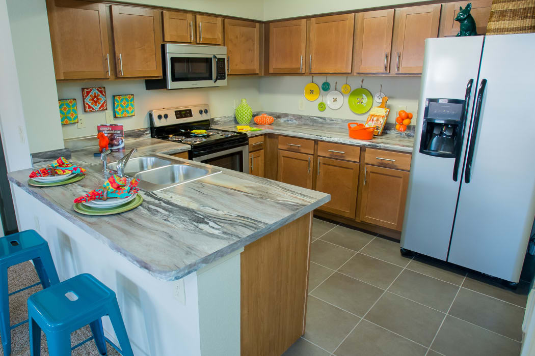 Kitchen with stainless steel appliances at Icon at Norman in Norman, Oklahoma