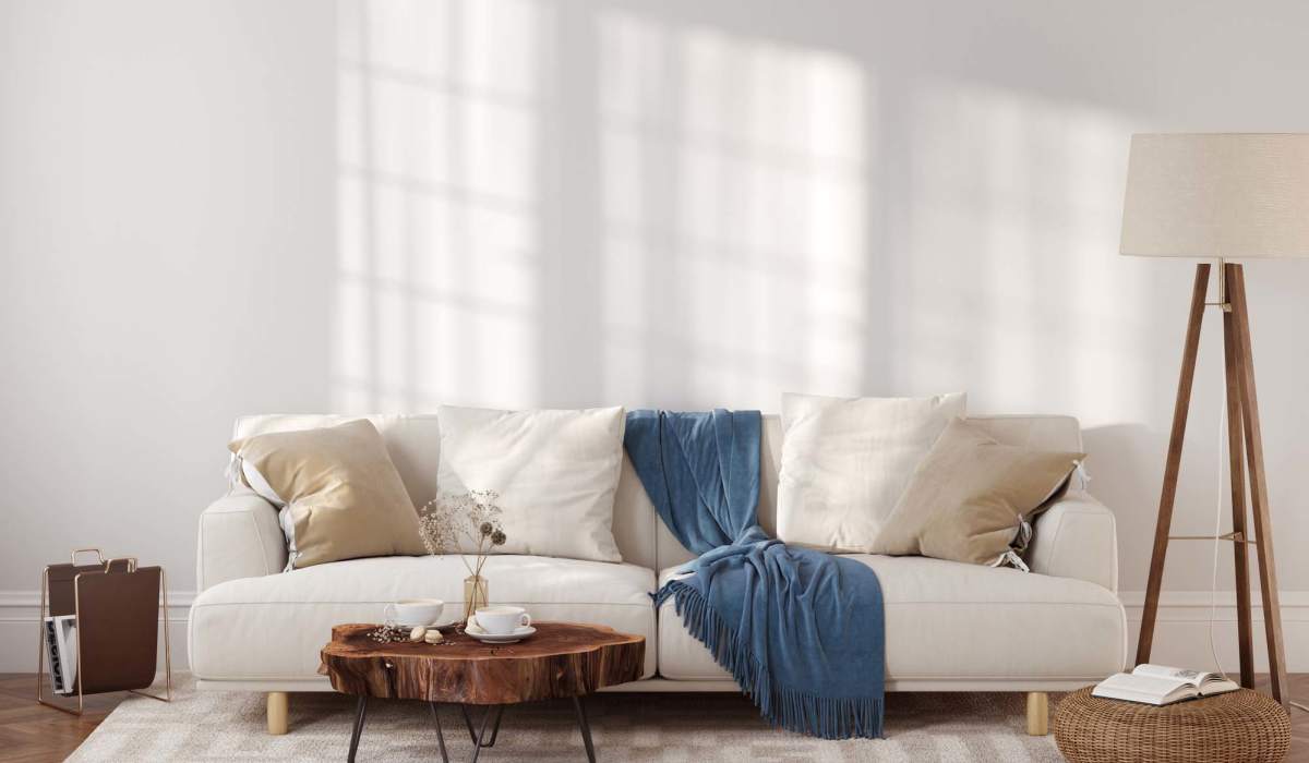 A white couch in a cozy room featuring a rug and a lamp, located at Granite Creek in Rocklin, California.