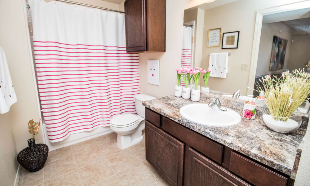 Bright bathroom with extra cabinet at Tuscany Place in Lubbock, Texas.