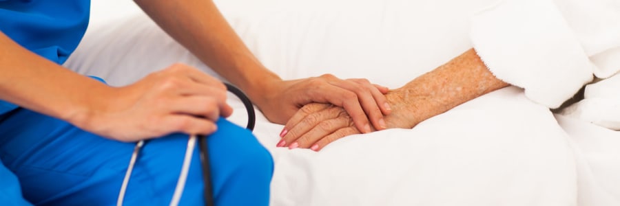 Resident holding hands with caregiver at Geneva Lake Manor in Lake Geneva, Wisconsin