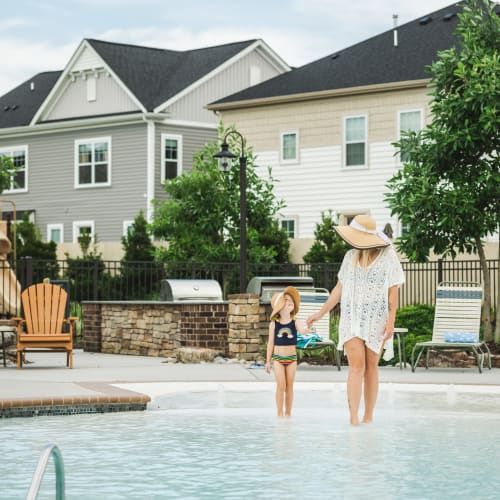 Mother and daughter walking through the pool at Dragas Home Rentals in Virginia Beach, Virginia